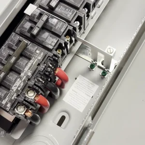 Photo of Interlockkit's adjustable single column breaker retainer securing a generator breaker in an electrical panel