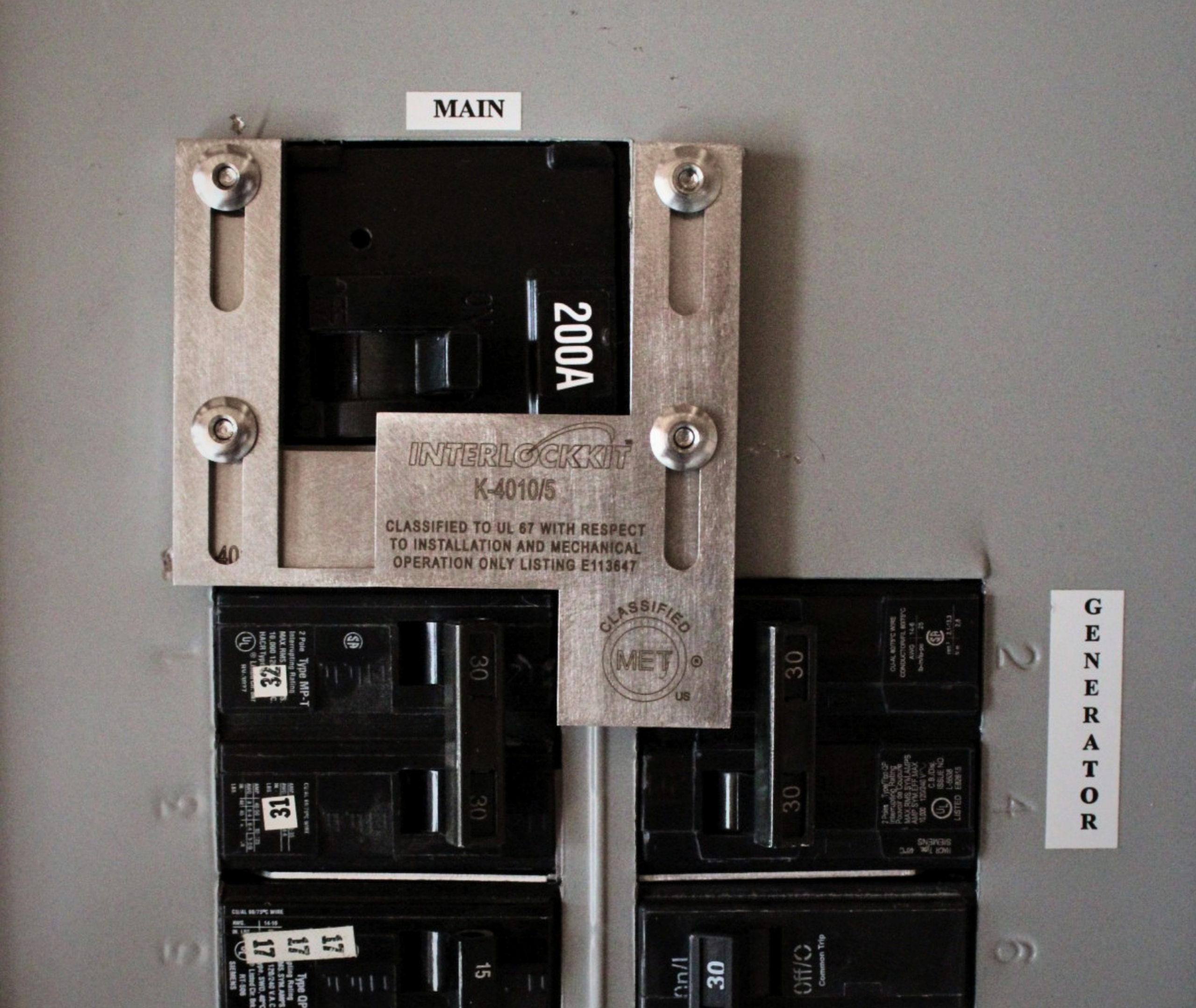 Interlockkit K-4010/5 Generator Interlock Kit Installed on a 200A Panel Interlockkit K-4010/5 generator interlock kit installed on a 200A residential electrical panel with main and generator breakers labeled